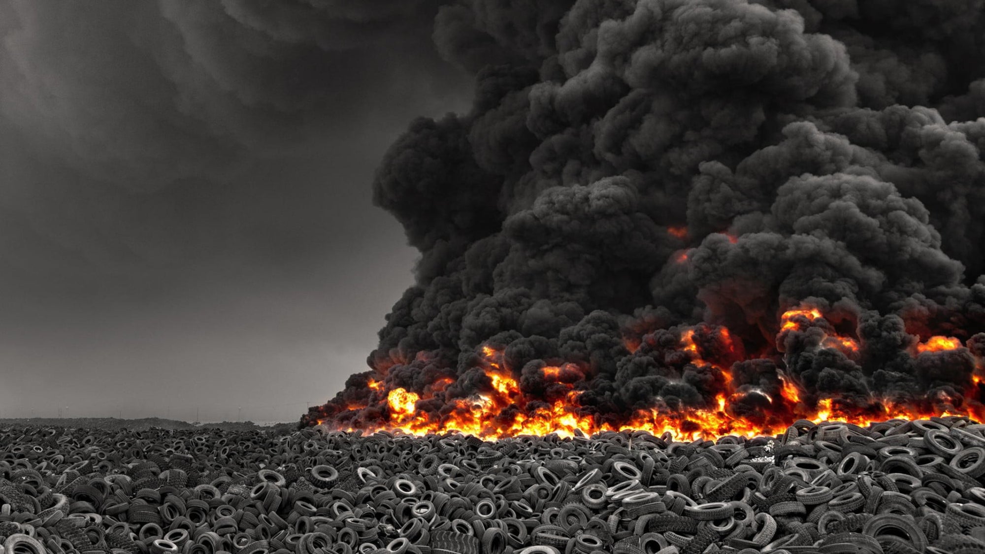 A dark Image of a large quantity of Burning Tire showing fossil fuels. Brining Awareness for World Health Day.